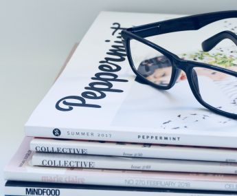 Photo of Eyeglasses On Top of Magazines