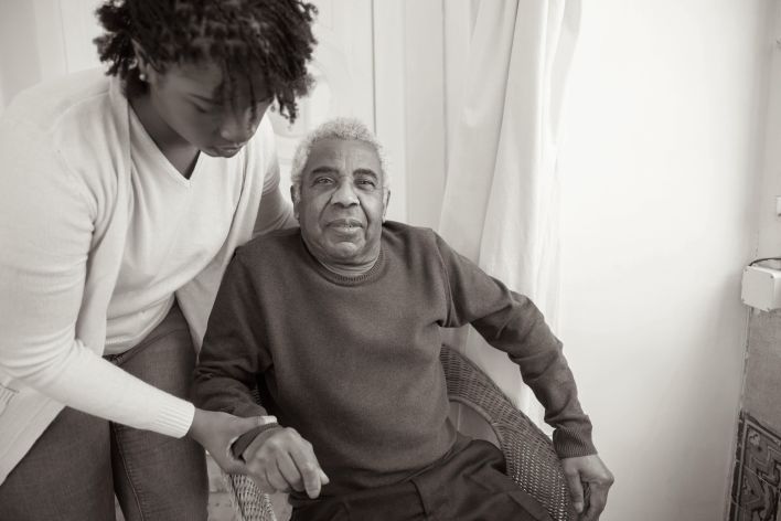 Woman Assisting Elderly Man