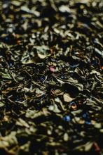 Close-up view of assorted dried tea leaves with a focus on texture and color contrast.
