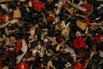 Rich close-up of a colorful herbal tea blend, combining dried fruits, leaves, and flowers for a perfect brew.