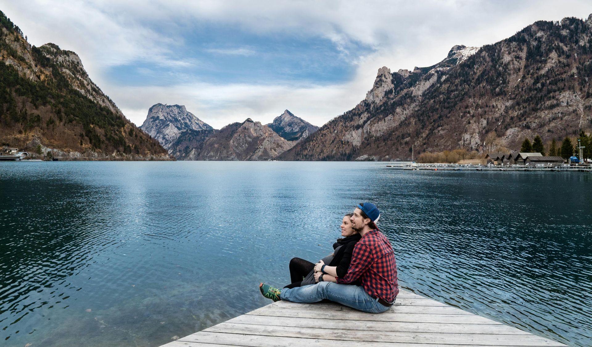 Couple enjoying a scenic view of the lake and mountains in Ebensee, Austria.