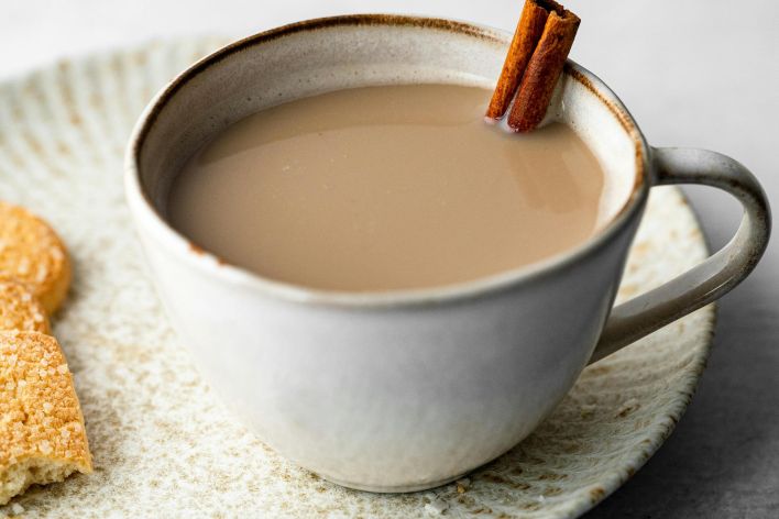 A cozy chai latte served in a ceramic cup with cinnamon stick, perfect for comforting moments.